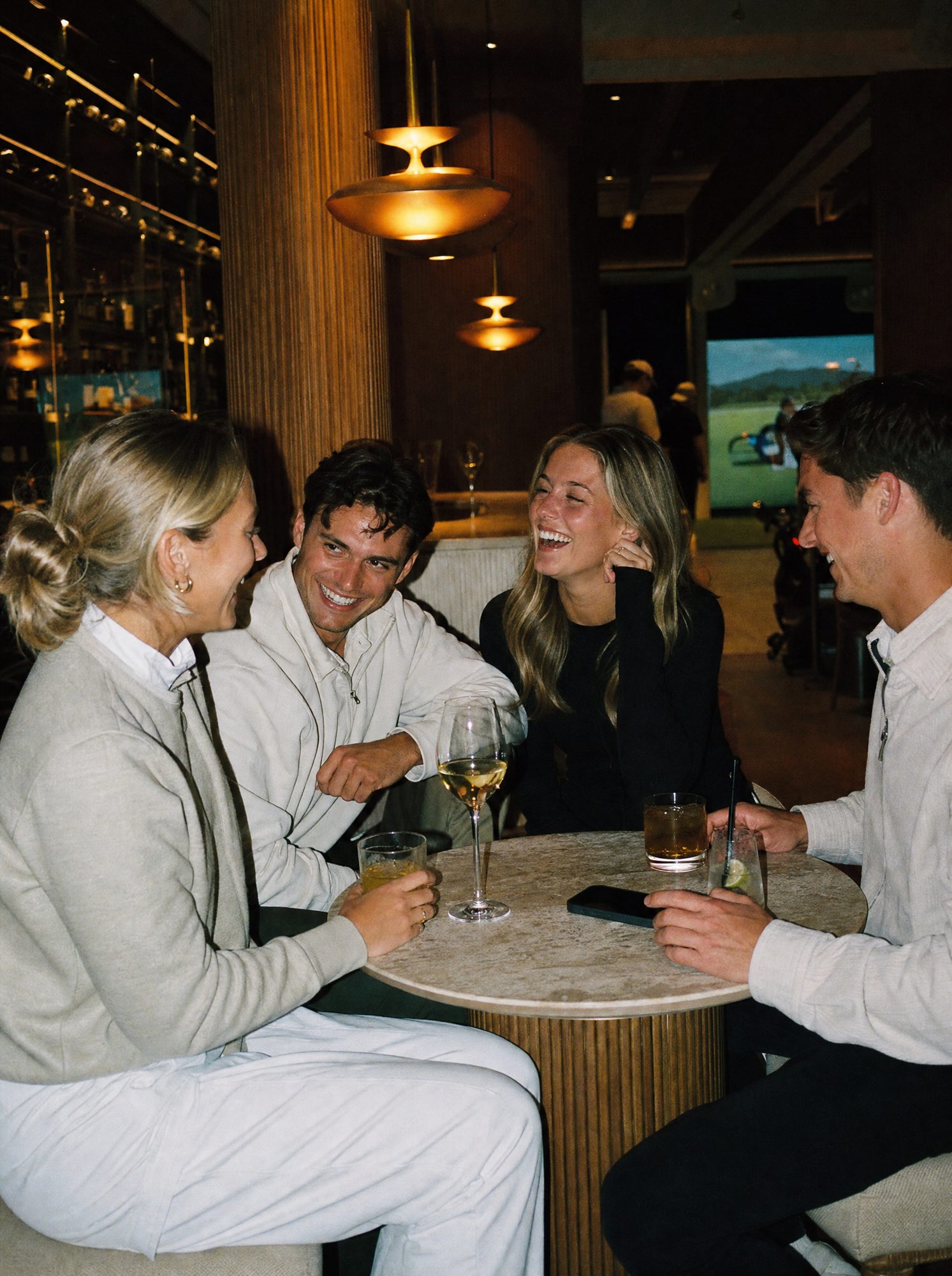 Golfers socialising at a table in a venue lounge